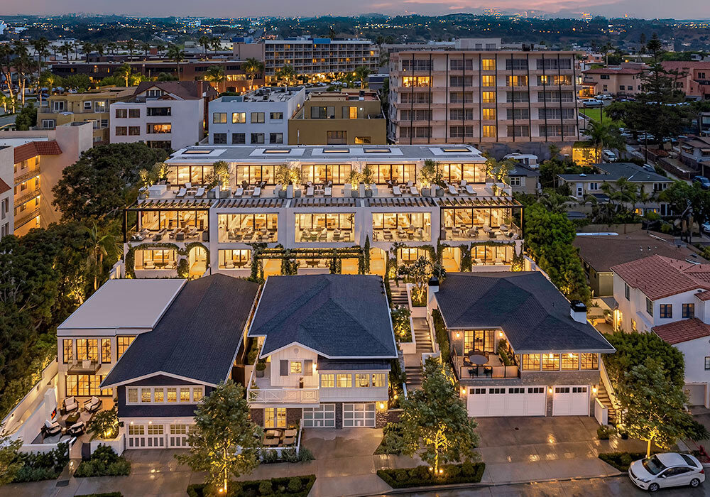 evening drone view rendering of multifamily and luxury residences